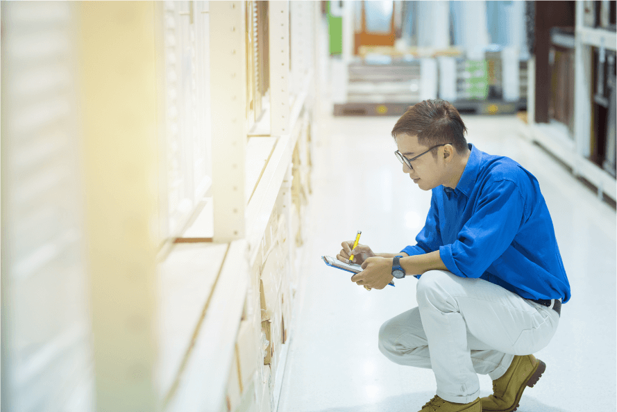 Grocery warehouse employee checking stock