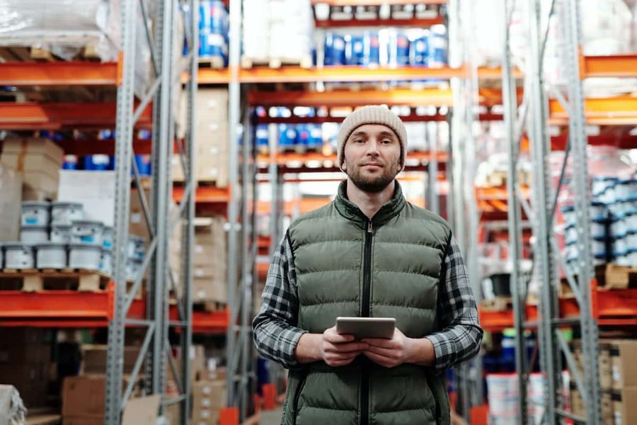 retail employee holding a retail predictive analytics tool